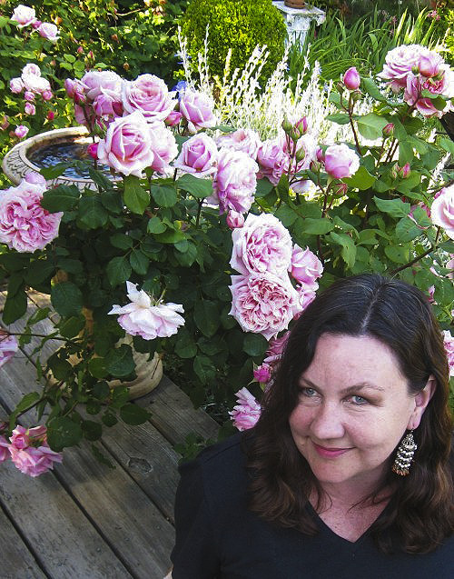 Simone Martel in her garden with roses.